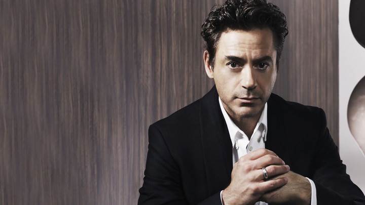 Robert Downey, Jr Sitting Pose In Black Coat